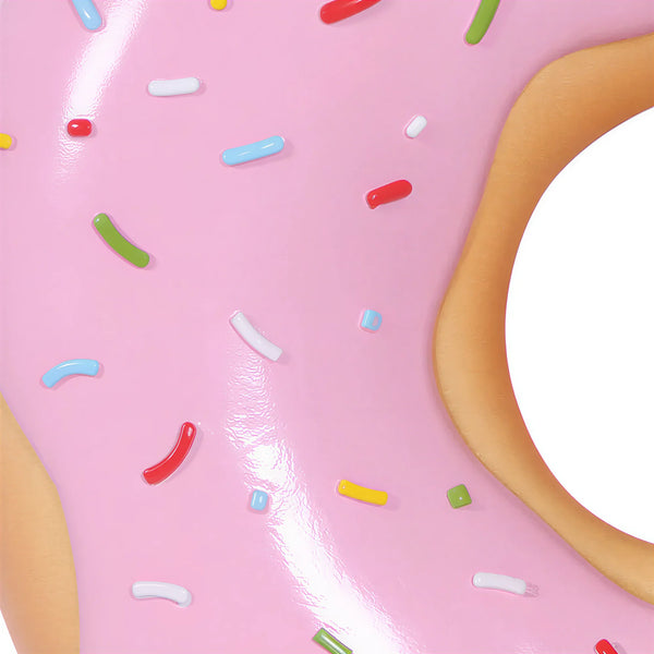 15-inch pink frosted donut wall decor with colorful sprinkles, commercial retail display prop by Heinimex in close up view