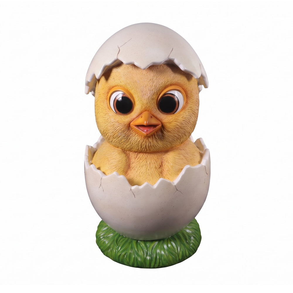 Heinimex Easter Chick 4ft event prop, textured yellow finish with cracked white eggshell and green grass base, playful outdoor spring display style angle view