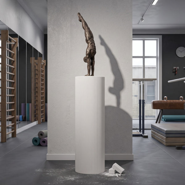 Heinimex Gymnast on Groovy Pedestal sculpture, textured Imperial Bronze finish on matte white, modern luxury gallery style lifestyle setting