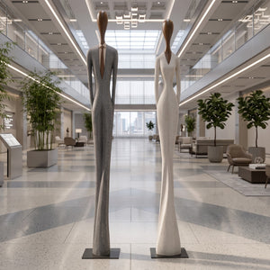 Heinimex Paya and Payo elongated human figure statues, textured stone-look and smooth wood-tone finish, modern minimalist gallery lifestyle setting.