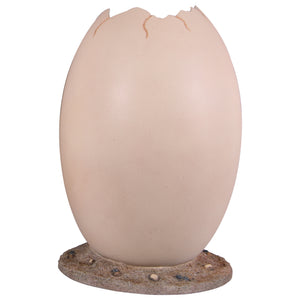 Heinimex Peekaboo Egg without top photo op, smooth speckled beige finish on textured rock base, immersive prehistoric playground style front view