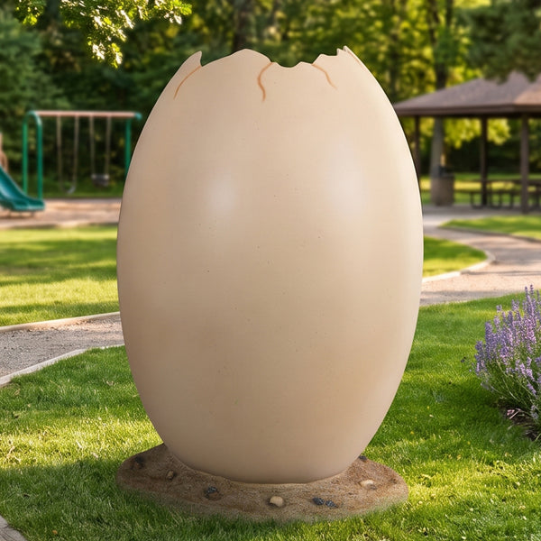 Heinimex Peekaboo Egg without top photo op, smooth speckled beige finish on textured rock base, immersive prehistoric playground lifestyle setting