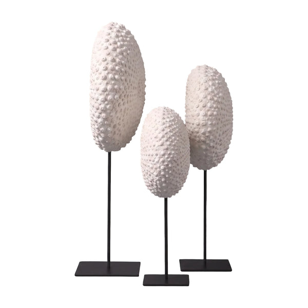 Heinimex Sea Urchin on Stand centerpiece, textured white stone finish with black metal stand, modern coastal luxury style on set side view