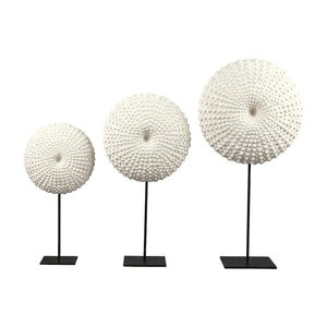 Heinimex Sea Urchin on Stand centerpiece, textured white stone finish with black metal stand, modern coastal luxury style in set front view