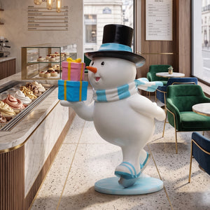 Heinimex Skating Snowman Family - Father Christmas decor, glossy painted finish with blue accents and colorful gifts, playful winter wonderland display lifestyle photo