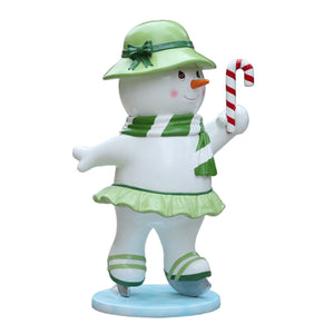 Heinimex Skating Snowman Family - Mother Christmas decor, glossy painted finish with green accents and candy cane, playful winter wonderland display style side view