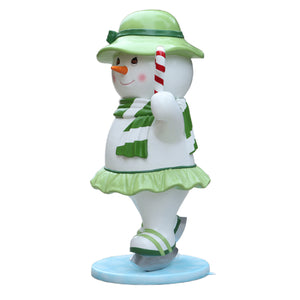 Heinimex Skating Snowman Family - Mother Christmas decor, glossy painted finish with green accents and candy cane, playful winter wonderland display style angle view