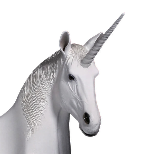 Functional and decorative white unicorn bench featuring a contoured seating area, a textured silver-grey mane, and a resting pose.
