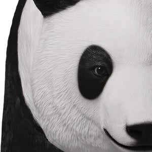 Decorative statue of a walking giant panda featuring a realistic black and white textured coat.