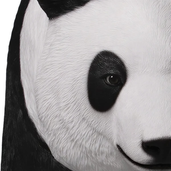 Decorative statue of a walking giant panda featuring a realistic black and white textured coat.
