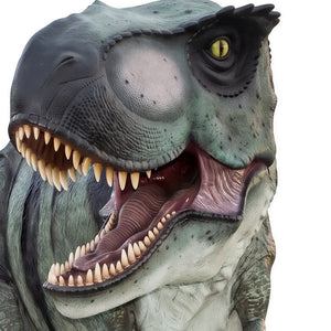 Decorative statue of a walking Tyrannosaurus Rex featuring greyish-green skin with dark stripes, a pale underbelly, and an open roaring mouth.