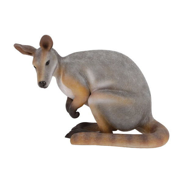 Decorative statue of a crouching wallaby featuring a grey and tan coat, upright ears, and a thick tail resting on the ground.