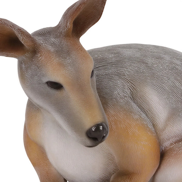 Decorative statue of a crouching wallaby featuring a grey and tan coat, upright ears, and a thick tail resting on the ground.