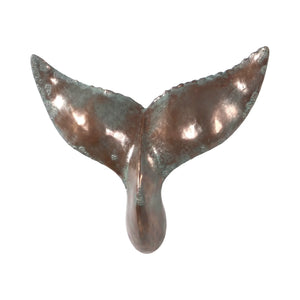 Decorative wall-mounted whale tail sculpture featuring a metallic copper finish with green patina accents.