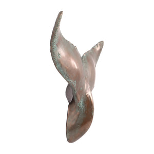 Decorative wall-mounted whale tail sculpture featuring a metallic copper finish with green patina accents.