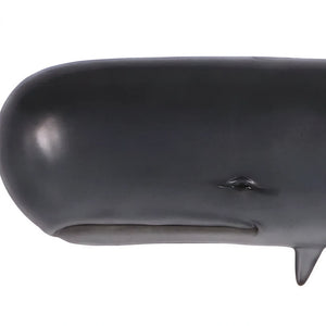 Decorative wall-mounted sculpture of a dark grey sperm whale featuring a prominent blunt head and a raised, curved tail.