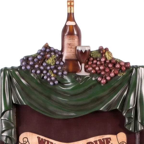 Decorative freestanding menu board featuring a dark writing surface topped with a sculpted wine bottle, grapes, and a Wine and Dine banner.