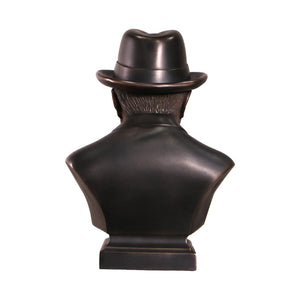 Decorative dark bronze-finished bust of Winston Churchill wearing a hat and bow tie, with a sculpted cigar in his mouth.