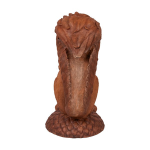 Decorative statue of a large brown squirrel holding an acorn, sitting upright on a textured base with additional acorns.