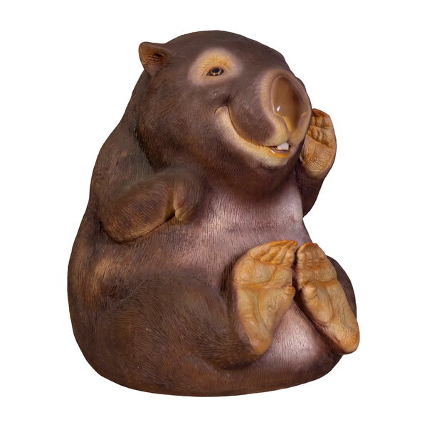 Decorative statue of a smiling wombat sitting upright with a brown finish and large textured foot pads.