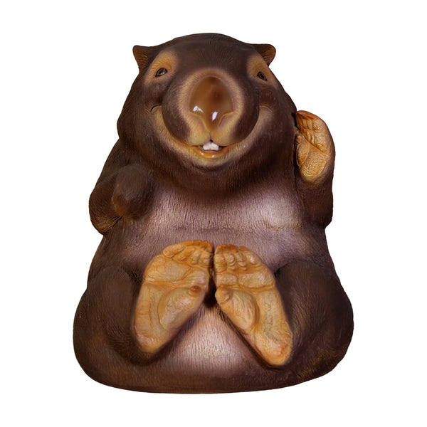 Decorative statue of a smiling wombat sitting upright with a brown finish and large textured foot pads.