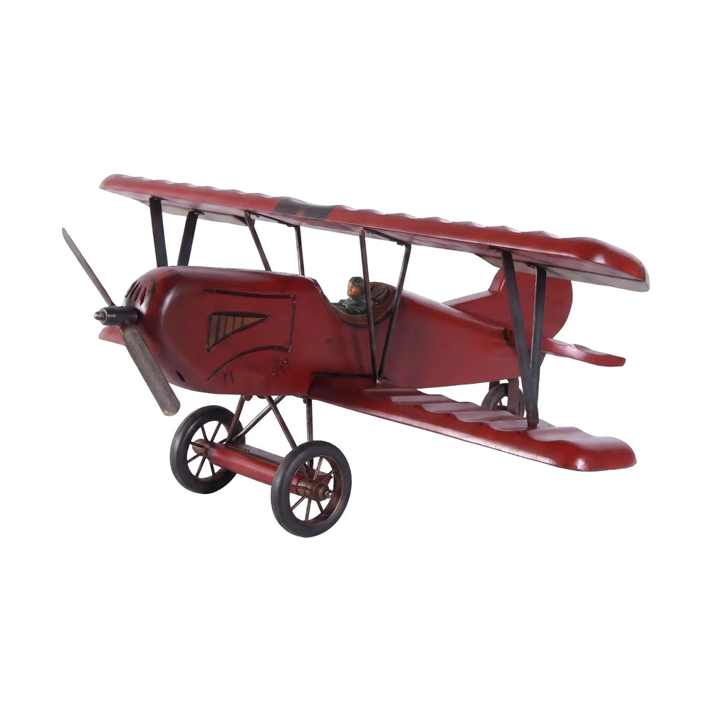 Decorative wooden biplane model featuring a dark red finish, spoked wheels, and a small pilot figure.