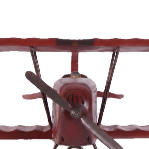 Decorative wooden biplane model featuring a dark red finish, spoked wheels, and a small pilot figure.