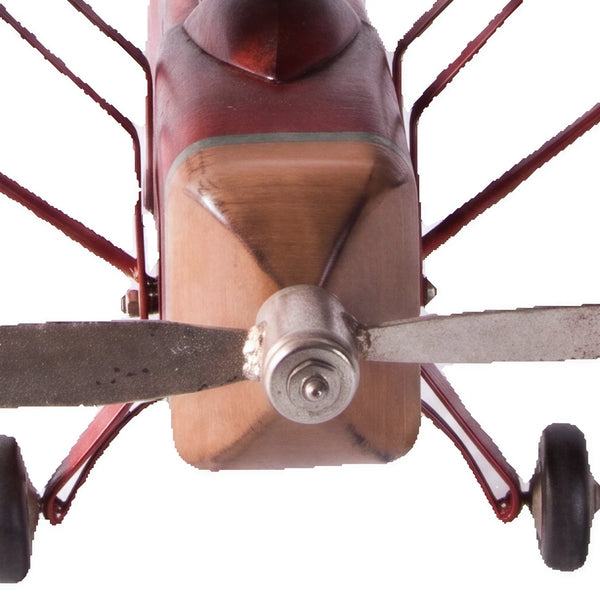 Decorative vintage airplane model featuring a red fuselage, wood-toned wings, and a silver propeller.