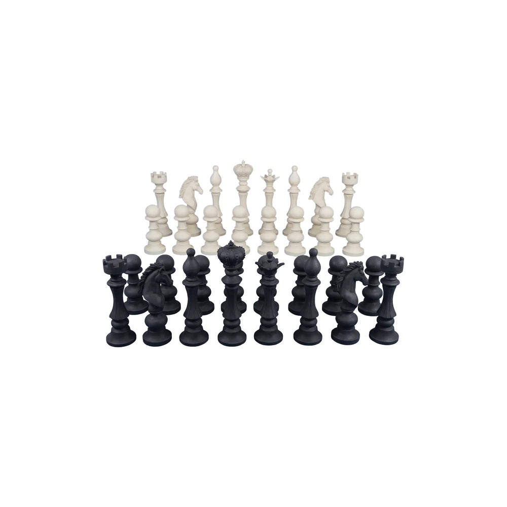 Decorative set of black and white chess pieces featuring traditional shapes like kings, queens, and knights.