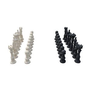 Decorative set of black and white chess pieces featuring traditional shapes like kings, queens, and knights.