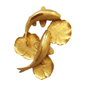 Decorative gold sculpture featuring two koi fish swimming among textured lily pads.