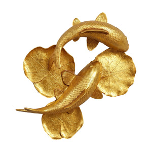 Decorative gold sculpture featuring two koi fish swimming among textured lily pads.