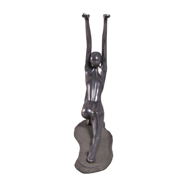 Decorative abstract sculpture of a figure in a yoga lunge pose with a smooth dark finish.