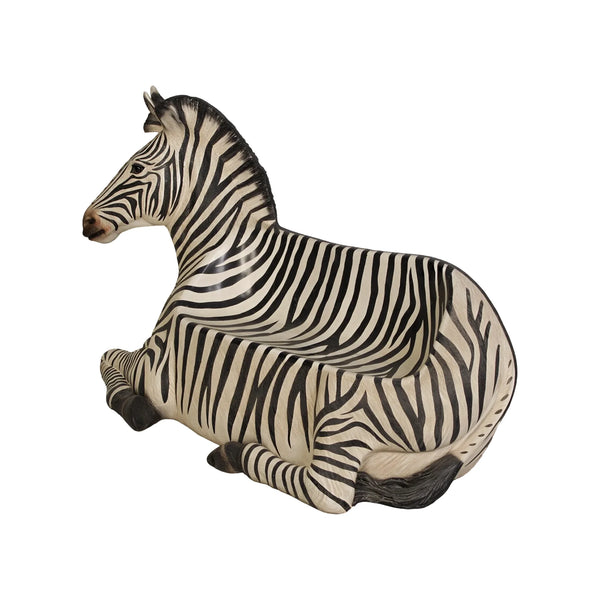 Decorative chair designed to look like a resting zebra with black and white stripes and an integrated seat.