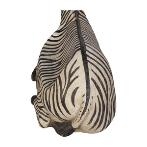 Decorative chair designed to look like a resting zebra with black and white stripes and an integrated seat.