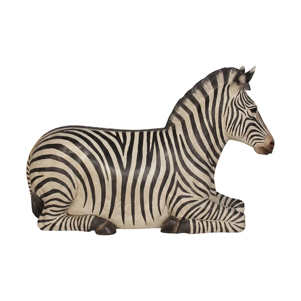 Decorative chair designed to look like a resting zebra with black and white stripes and an integrated seat.