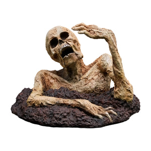 Decorative skeleton statue appearing to crawl out of a dirt base, featuring weathered bone textures and an open mouth.